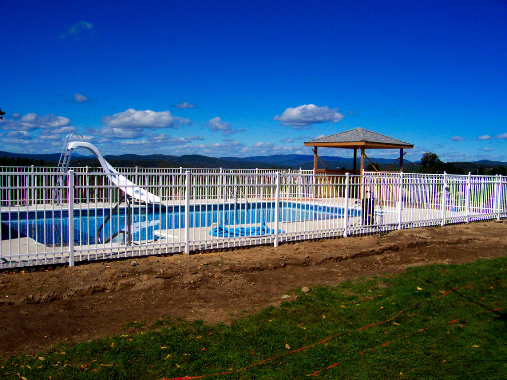 Residential white ornamental rail fence pool enclosure installation
